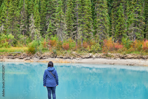 Rear view of woman looking at view while standing at Banff National Park