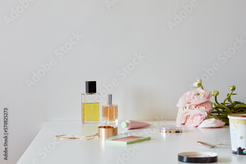 Still life with perfume bottles, beauty products, ice cream, roses photo