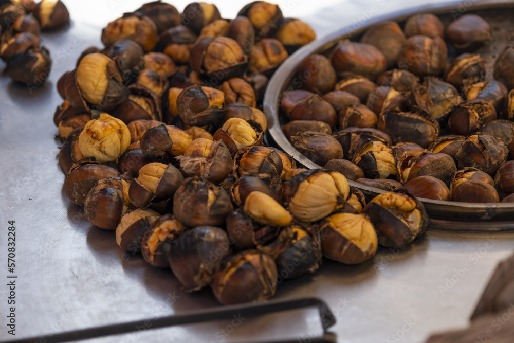 Delicious roasted chestnuts, street food and peddler concept, traditional Turkish chestnut on stand in Istanbul, travel in Turkey idea, many hot nuts, Turkish cuisine Delicious roasted chestnuts, street food and peddler concept, traditional Turkish chestnut on stand in Istanbul, travel in Turkey idea, many hot nuts, Turkish cuisine