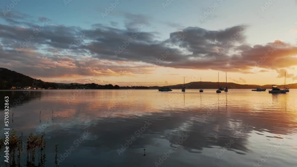 Sunrise, clouds and boat reflections on Brisbane Water at Koolewong and Tascott on the Central Coast, NSW, Australia. Sunrise, clouds and boat reflections on Brisbane Water at Koolewong and Tascott on the Central Coast, NSW, Australia.
