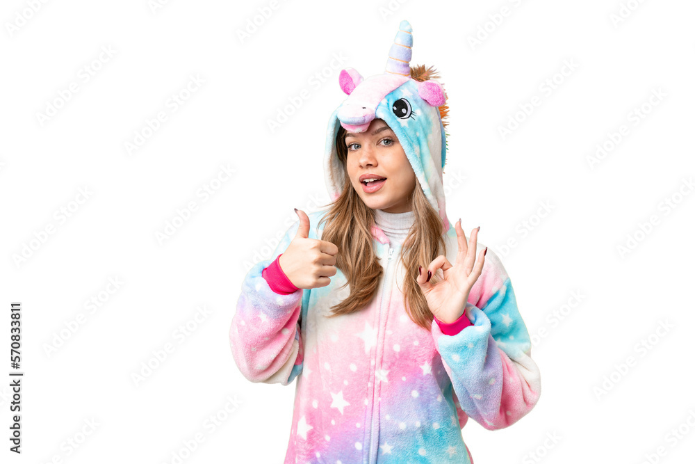 Young girl with unicorn pajamas over isolated chroma key background showing ok sign and thumb up gesture Young girl with unicorn pajamas over isolated chroma key background showing ok sign and thumb up gesture