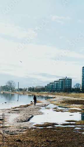 Photography person walking on the beach in winter