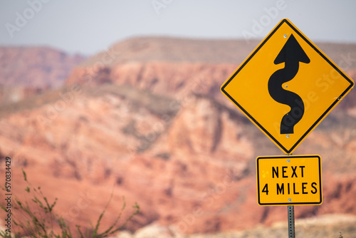 Road sign explaing that next four miles comes winding road