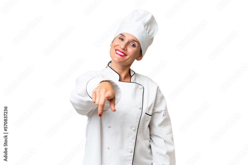 Middle-aged chef woman over isolated background points finger at you with a confident expression Middle-aged chef woman over isolated background points finger at you with a confident expression