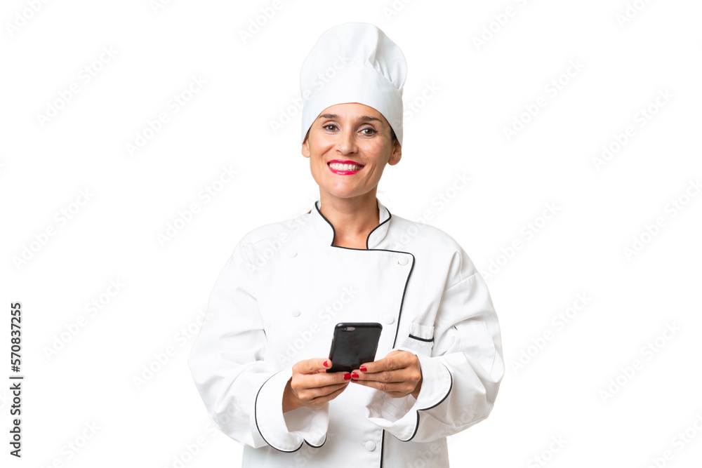 Middle-aged chef woman over isolated background sending a message with the mobile