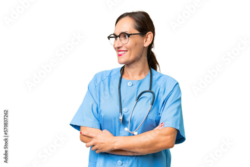 Middle-aged nurse woman over isolated background looking side © luismolinero