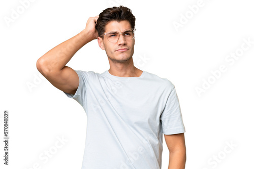 Carta da parati Young caucasian handsome man over isolated background having doubts while scratc