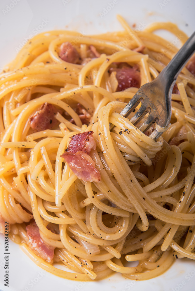 Spaghetti carbonara with parmesan cheese on a marble table. Spaghetti carbonara with parmesan cheese on a marble table.