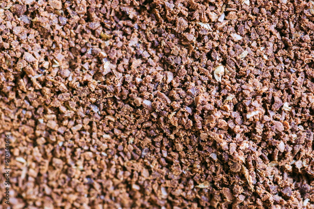 The grains of ground black coffee are very close. Close up groun The grains of ground black coffee are very close. Close up groun