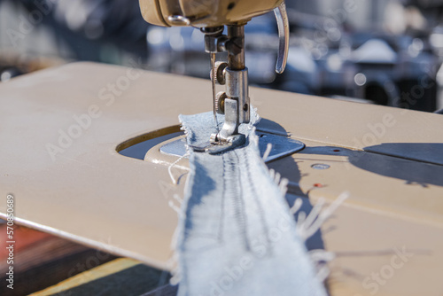 Fotografering Sewing machine makes a seam on fabric