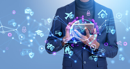 African businessman with tablet, earth sphere and diverse insurance icons