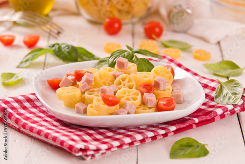 Ruote pasta with tomato and ham.