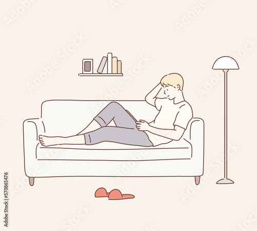 Portrait of a casual man lying on the sofa with tablet computer. Hand drawn style vector design illustrations.