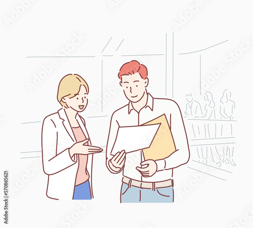 Two business people discussing work.Man and woman working at an office talking about files or project. Hand drawn style vector design illustrations.