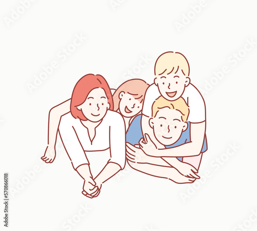 Beautiful and happy smiling young family in white T-shirts are hugging and have a fun time together while lying on the floor and looking on camera. Hand drawn style vector design illustrations.