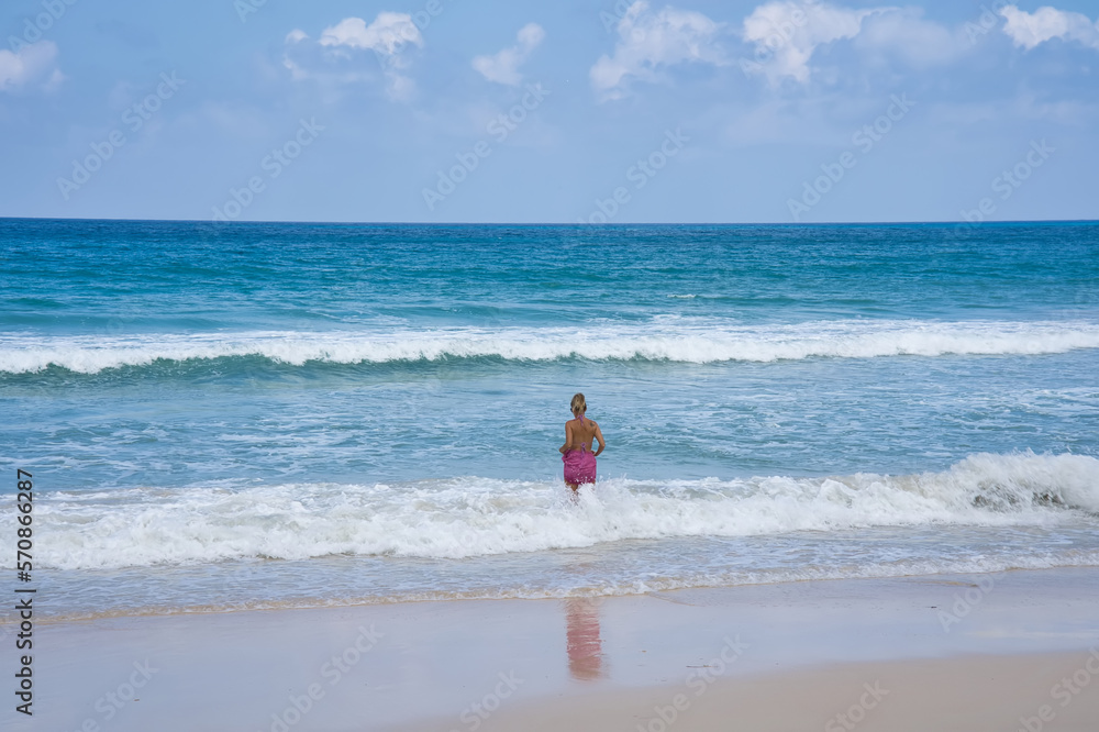 Clients on th beach standing in the water