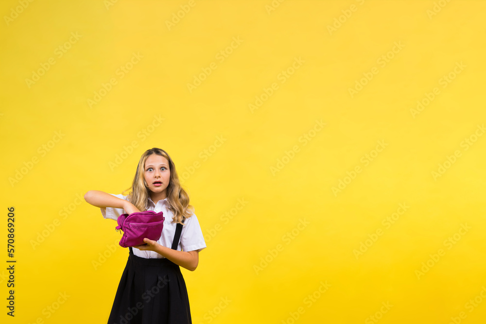 Happy schoolgirl with colored pencils and a pencil case in hand Happy schoolgirl with colored pencils and a pencil case in hand
