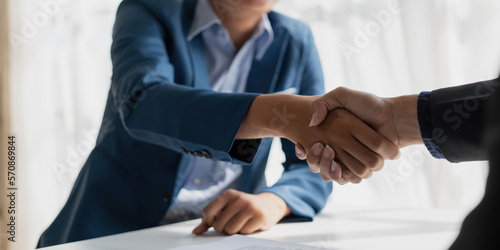 Handshake of cooperation customer and salesman after agreement, successful car loan contract buying or selling new vehicle photo