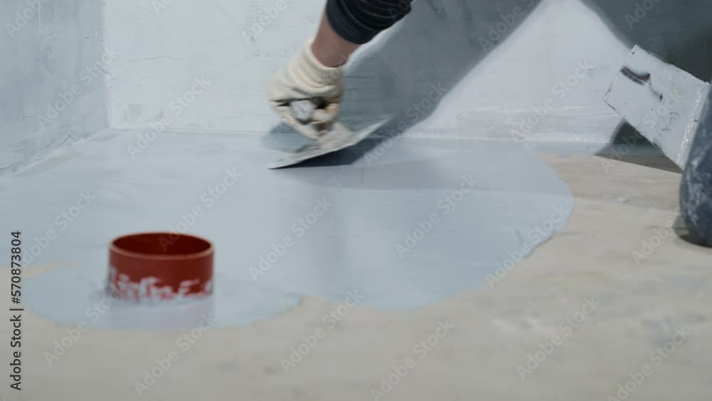 manual waterproofing of floors on the construction site with trowel manual waterproofing of floors on the construction site with trowel