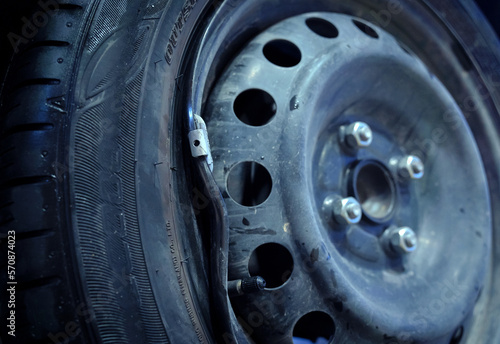 Car with a punctured and broken wheel in a car repair shop