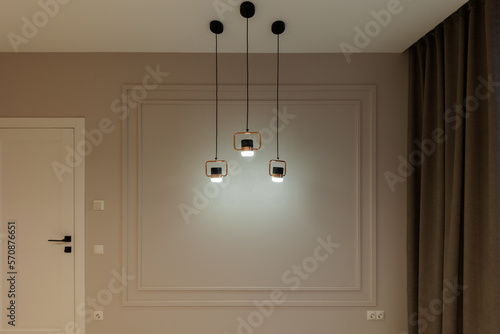 A modern lamp in a gray room. Interior