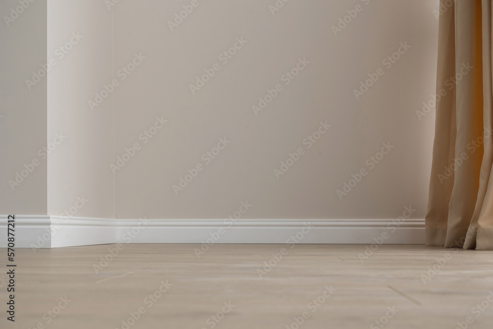 Plinth on laminate. the floor of a new apartment Plinth on laminate. the floor of a new apartment