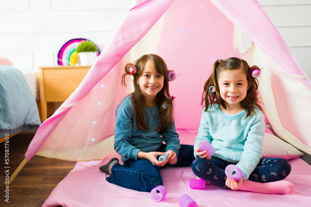 Little girls playing with their hair and smiling Stock Photo | Adobe Stock