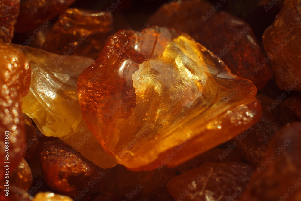 Fototapeta premium Close-up of raw amber resin with rich golden tones and natural texture. Ideal for themes of gemstones, nature's treasures, geology, fossilized resin, and organic materials