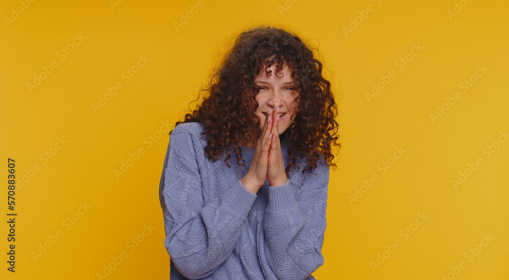 Sneaky cunning curly haired woman with tricky face gesticulating and scheming evil plan, thinking over devious villain idea, cheats, revenge, jokes, pranks. Girl isolated on yellow studio background Sneaky cunning curly haired woman with tricky face gesticulating and scheming evil plan, thinking over devious villain idea, cheats, revenge, jokes, pranks. Girl isolated on yellow studio background