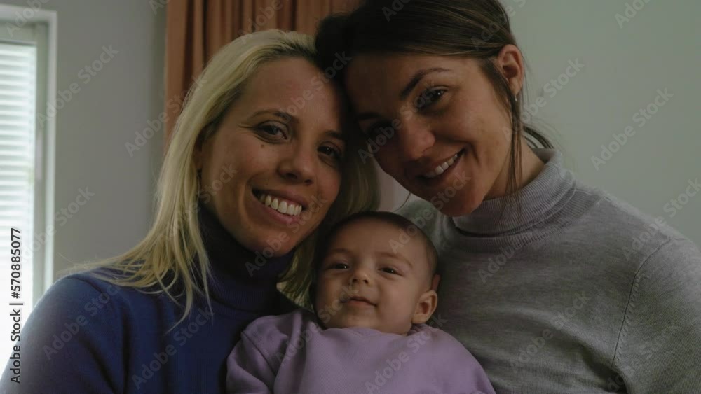 Happy lesbian couple with small baby at home portrait - LGBT family concept Happy lesbian couple with small baby at home portrait - LGBT family concept