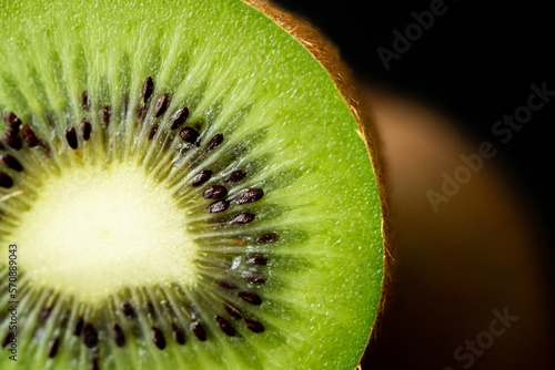 Ripe kiwi isolated on white background.Kiwi macro shot on an isolated background.Kiwi sliced.Macro photo of a kiwi with place for text.Macro photo of an exotic fruit on an isolated background.