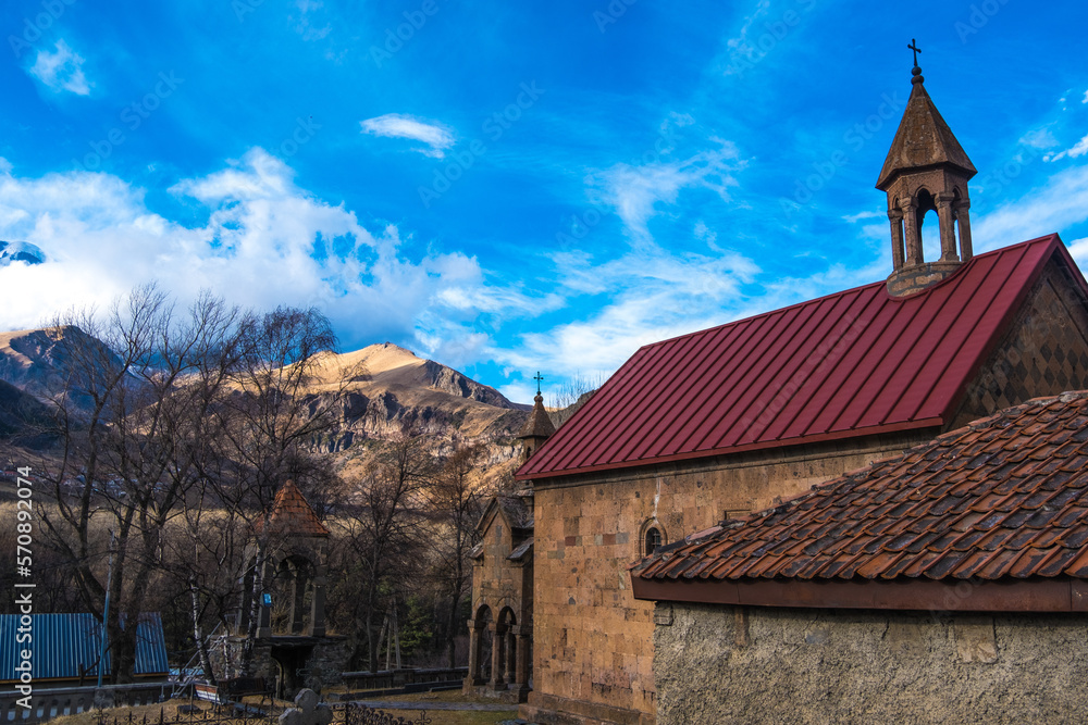 Obraz premium Kazbegi, Georgia : 10-11-2022 : Village Of Gergeti In Georgia, with the beautiful Caucasus mountain peaks and meadow surrounded