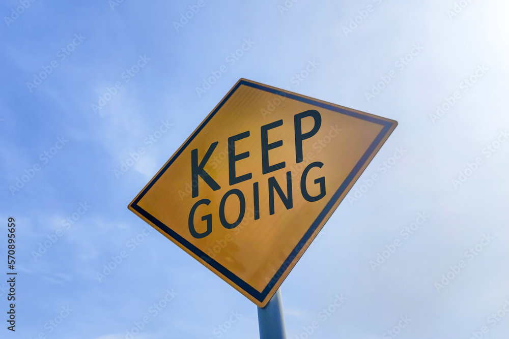 Keep going motivational message on road sign. Keep going motivational message on road sign.
