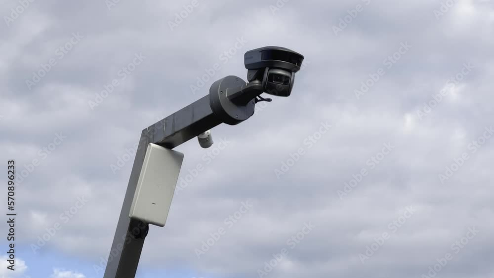 Security video camera moving to scan the area for surveillance purposes. Robotic CCTV recording technology. Security video camera moving to scan the area for surveillance purposes. Robotic CCTV recording technology.