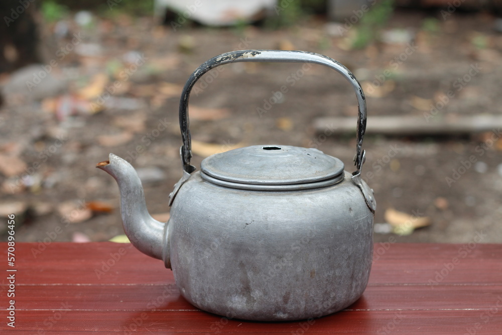 
old teapot on table isolated blur background