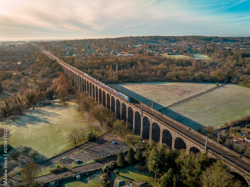 UK Commuter Train Travelling Across a Viaduct at Sunset