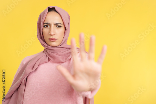 Muslim woman gesturing prohibition with hand