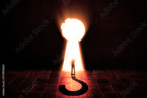 Confused Businessman Stand in Open key hole in dark room, light through the opened keyhole with big question mark.  photo