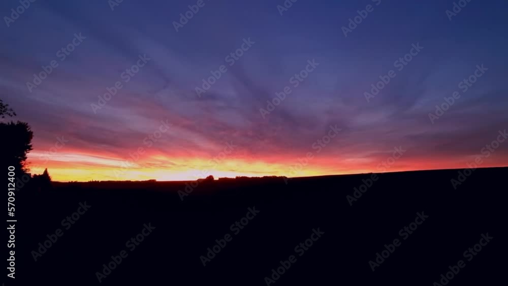 Sunsets with clouds and sunbeams in beautiful gigantic colors Sunsets with clouds and sunbeams in beautiful gigantic colors