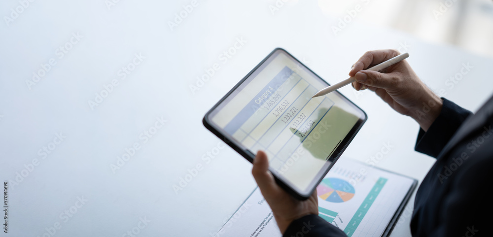 Cropped shot young businessman working while using digital tablet, preparing for the company meet. Cropped shot young businessman working while using digital tablet, preparing for the company meet.