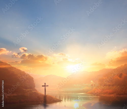 The wooden cross on a mountain with a sunset background