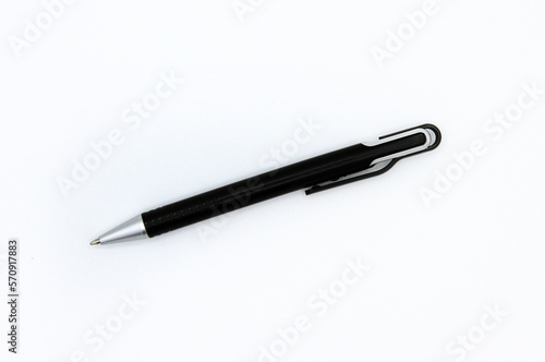 Flat lay of black modern pen or mechanical pencil isolated on white background. Top view of object for writing