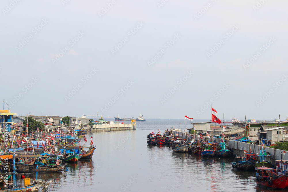 portrait of traditional fishing boats in fishing village near the river that connects to the sea