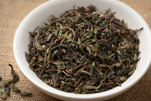 Bowl with organic Nepal Oolong Jun Chiyabari dried tea leaves