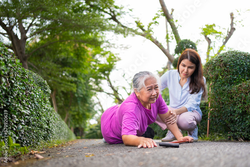 Asian senior woman fell down on lying floor because faint and limb weakness and Crying in pain form accident and her daughter came to help support. Concept of old elderly insurance and health care