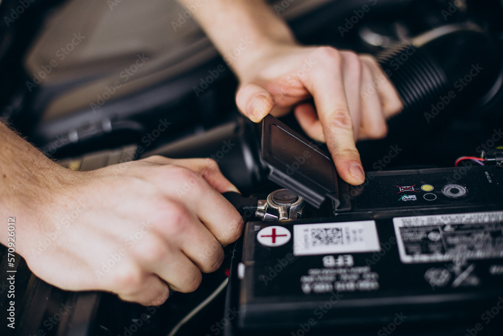 Repair man at car service doing car check up Repair man at car service doing car check up