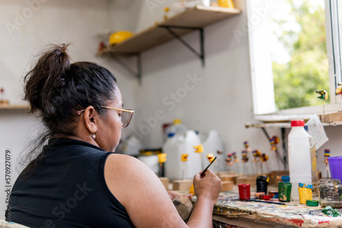 woman painting plate with brush is a cultural tradition of the carnival of barranquilla colombia photo