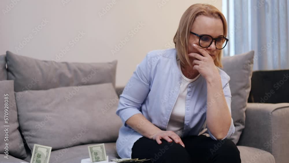 Stressed young woman calculating monthly home expenses, taxes, bank account balance and credit card bills payment, Income is not enough for expenses