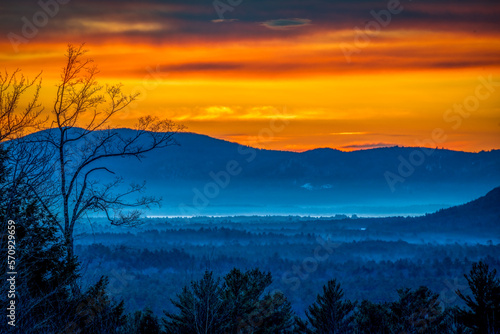 Orange sunrise over foggy mountains 