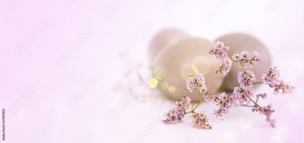 delicate flowers against the background of Easter eggs.Happy Easter concept. pink background. Selective focus